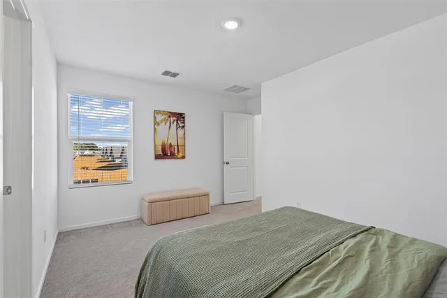 a bedroom with a bed and a couch