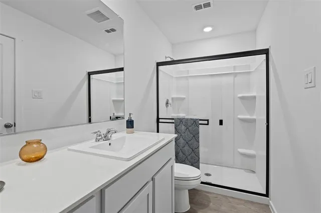 a bathroom with a sink toilet and shower