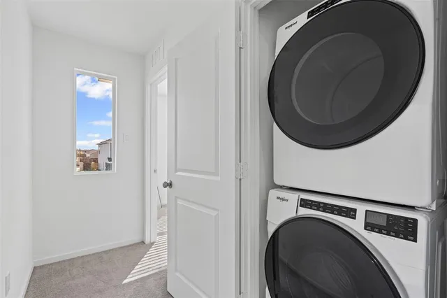 a view of a hallway with washer and dryer