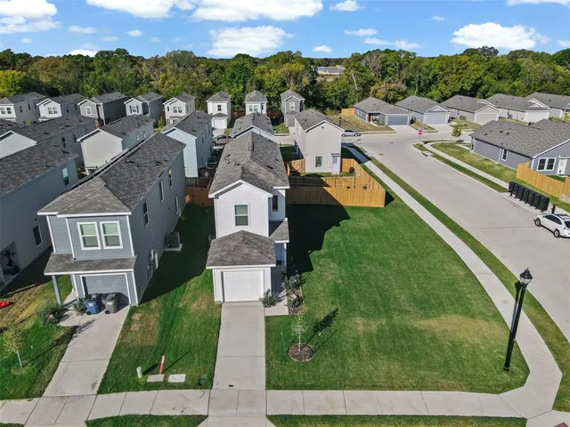 an aerial view of residential houses with outdoor space and street view