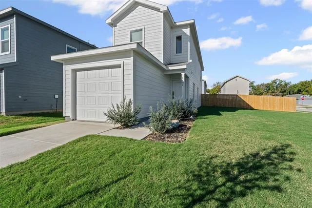 a view of a house with a yard and a fountain
