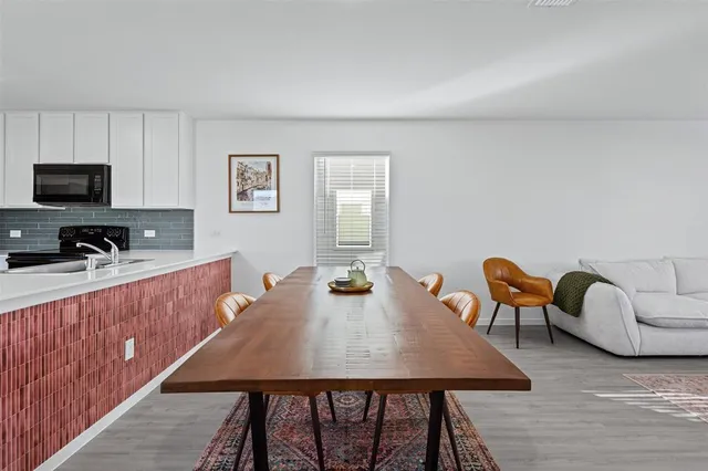 a view of a dining room with furniture window and wooden floor