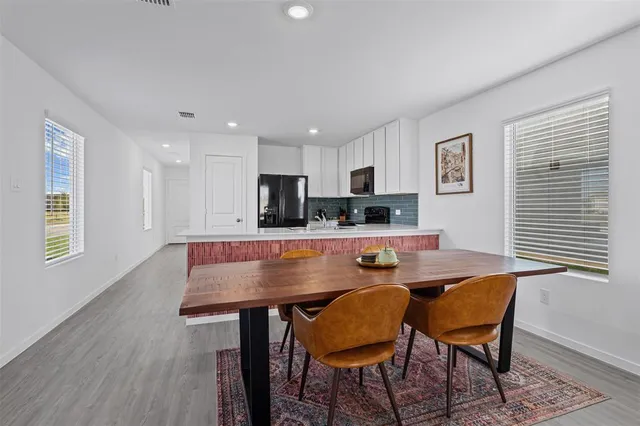 a view of a dining room with furniture and wooden floor