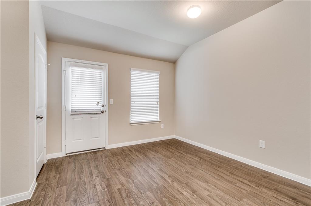 185 Voss Kyle, TX 78640 - Photo 12 of 26 an empty room with wooden floor and windows