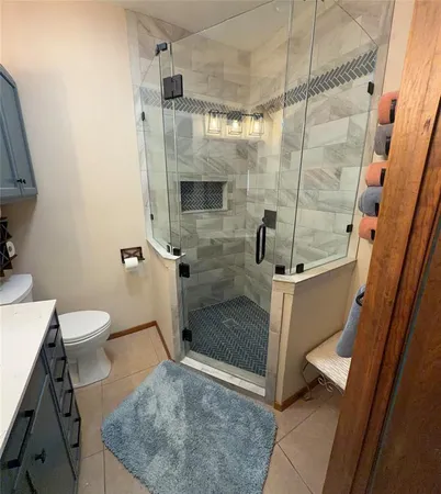 a bathroom with a shower and toilet
