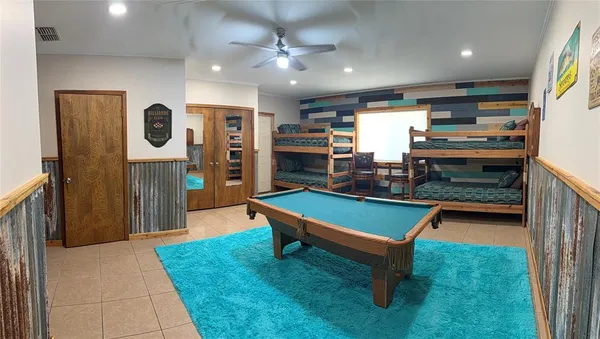 a room with furniture and pool table
