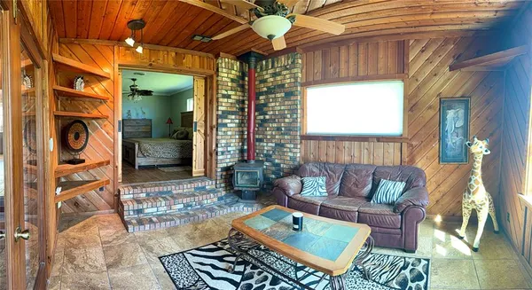a living room with furniture a chandelier and a fireplace