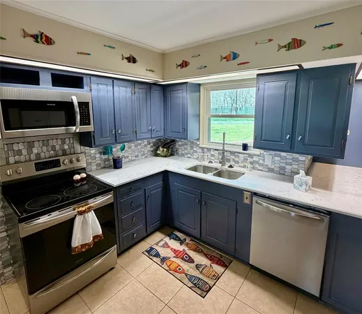 a kitchen with a sink stove and microwave