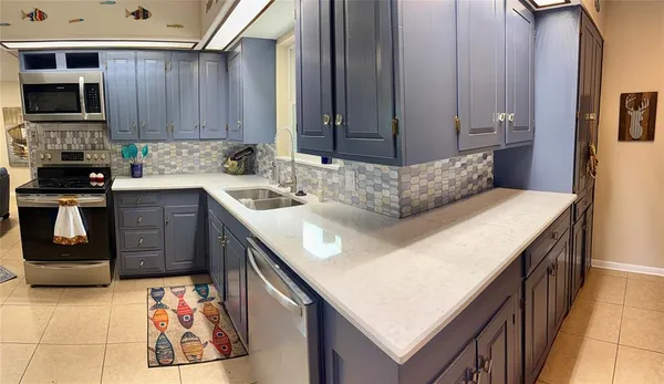 a kitchen with a stove top oven and sink