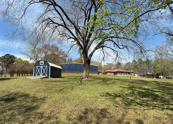 a view of a yard with a house and large trees