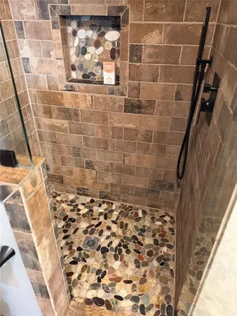 a bathroom with a shower and a sink