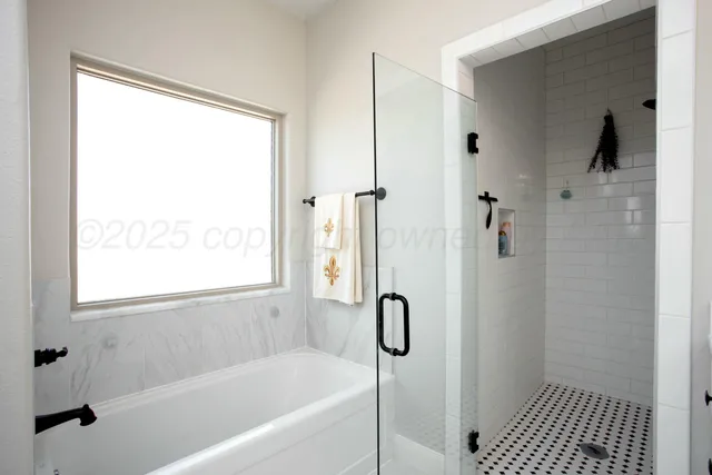 a bathroom with a bathtub and shower