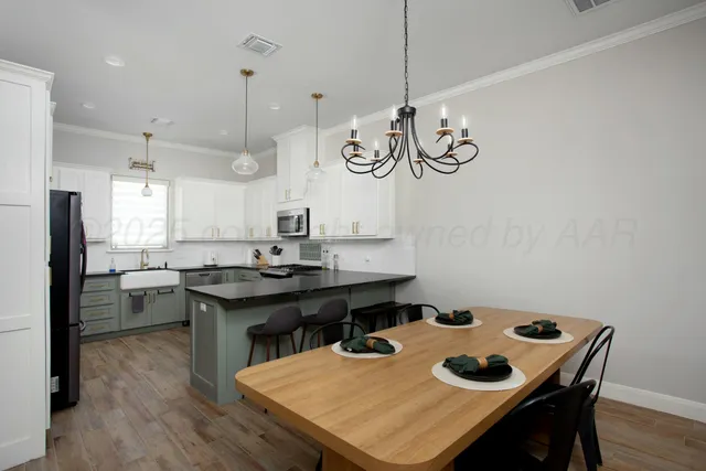 a kitchen with a table and chairs in it