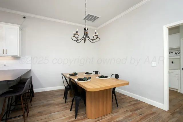 a view of a dining room with a table and chairs