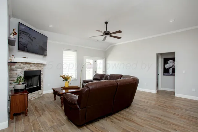 a living room with furniture fireplace and flat screen tv