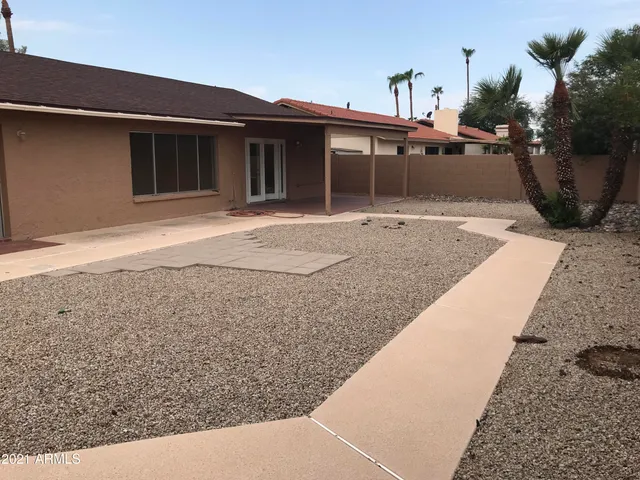 a view of a house with a backyard