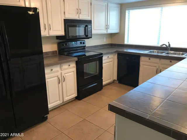 a kitchen with a sink and a stove top oven