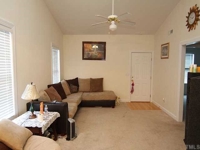 7024 Sandy Forks Road, Unit 301 Raleigh, NC 27615 - Photo 3 of 11 a living room with furniture and a ceiling fan