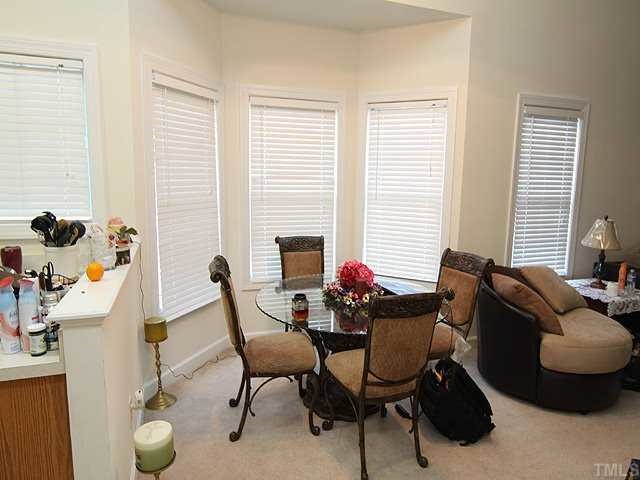 7024 Sandy Forks Road, Unit 301 Raleigh, NC 27615 - Photo 4 of 11 a living room with furniture and a window