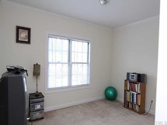 7024 Sandy Forks Road, Unit 301 Raleigh, NC 27615 - Photo 8 of 11 a room with furniture and a window