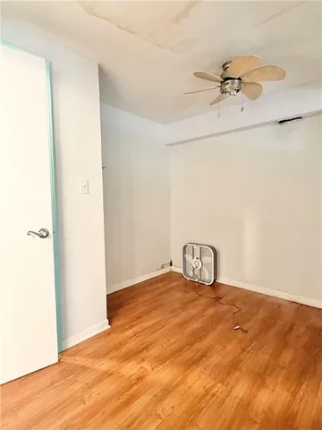 a view of a room with wooden floor
