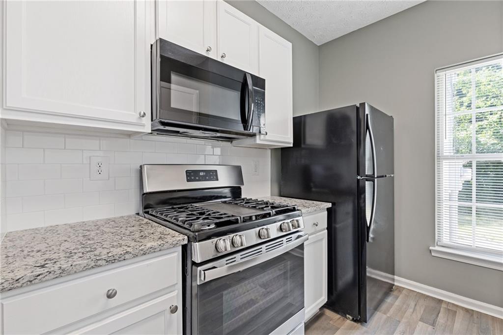 2566 Walden Lake Drive Decatur, GA 30035 - Photo 12 of 30 a kitchen with stainless steel appliances granite countertop a refrigerator stove and microwave