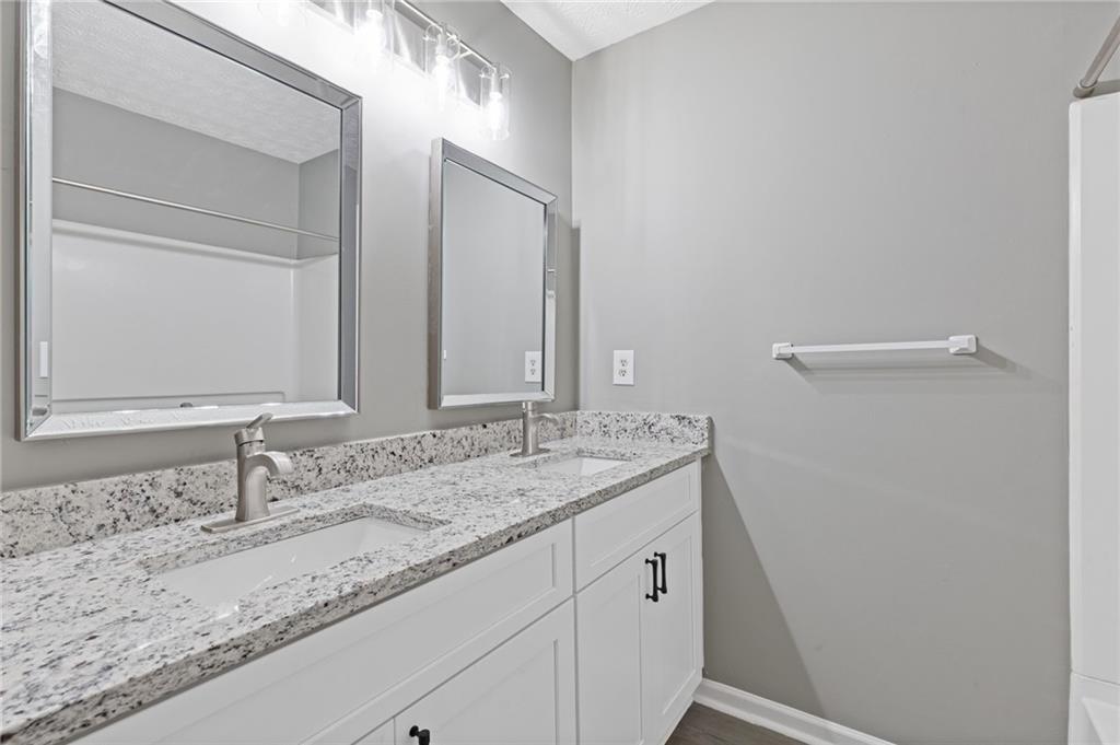 2566 Walden Lake Drive Decatur, GA 30035 - Photo 17 of 30 a bathroom with a granite countertop sink and a mirror