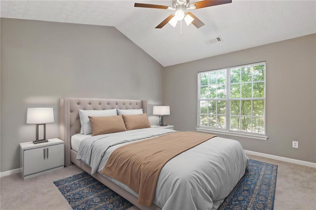 2566 Walden Lake Drive Decatur, GA 30035 - Photo 21 of 30 a bedroom with a large bed and a chandelier