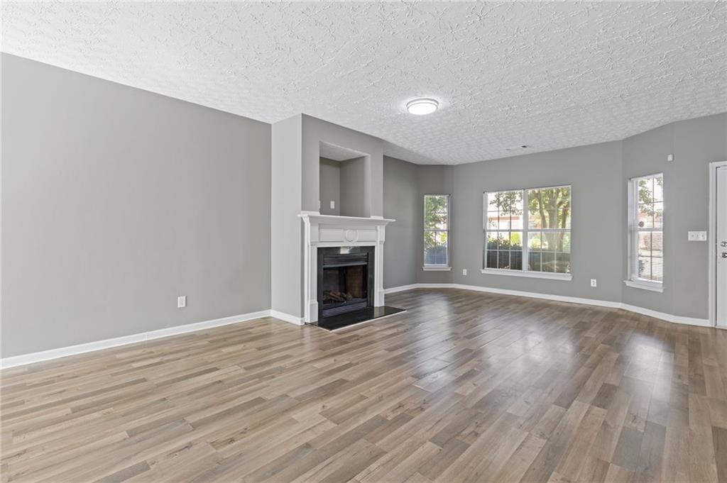 2566 Walden Lake Drive Decatur, GA 30035 - Photo 6 of 30 wooden floor fireplace and natural light in room