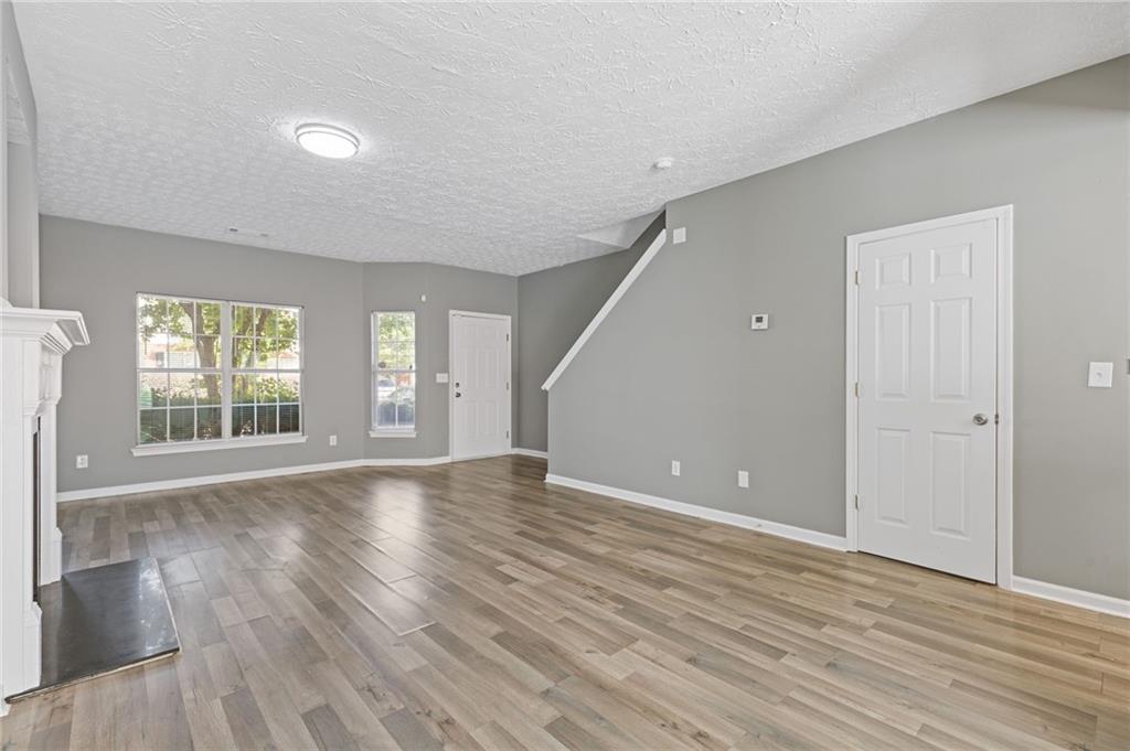 2566 Walden Lake Drive Decatur, GA 30035 - Photo 7 of 30 an empty room with wooden floor and windows