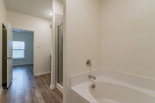 a bathroom with a bathtub and a shower