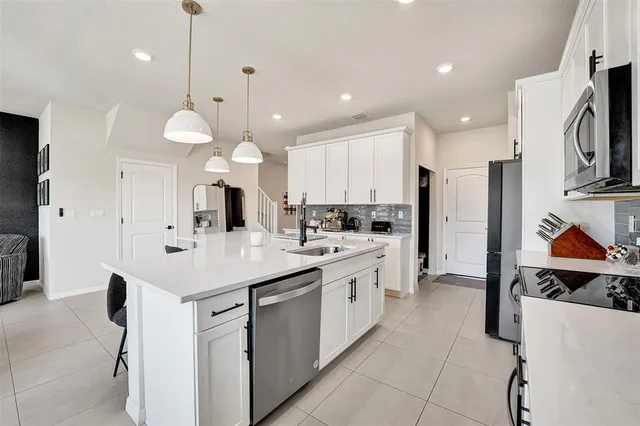 a living room with furniture and kitchen view