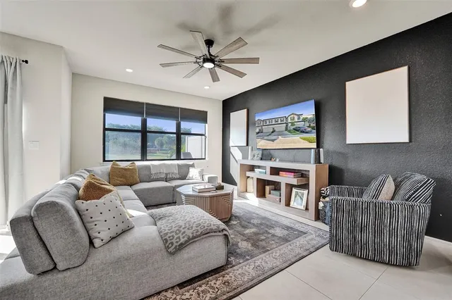 a living room with furniture a rug and a chandelier