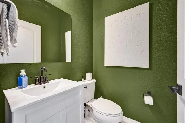 a bathroom with a sink a toilet and mirror