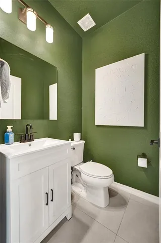 a kitchen with kitchen island granite countertop lots of stainless steel appliances and white cabinets