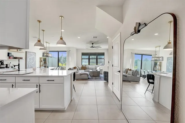 a kitchen with kitchen island granite countertop a sink a center island stainless steel appliances and cabinets