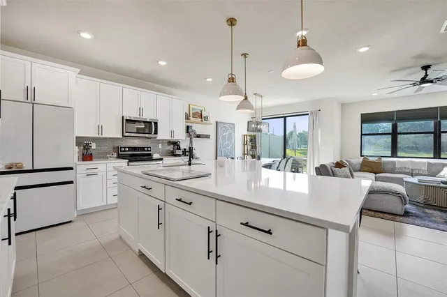 a kitchen with stainless steel appliances a stove sink and cabinets