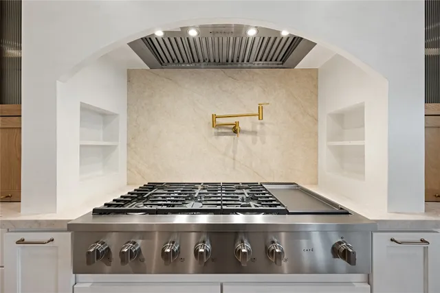 a view of an empty room with a fireplace and a window