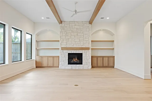 a view of empty room with a fireplace and cabinet