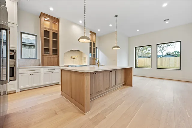 a kitchen with stainless steel appliances granite countertop a stove a sink and a refrigerator
