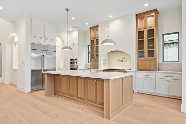 a kitchen with stainless steel appliances white cabinets and a stove