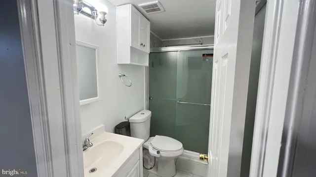 a white toilet sitting next to a bathroom sink