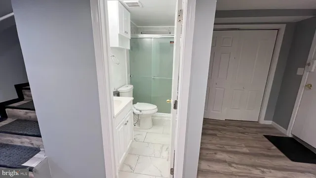 a bathroom with a toilet and a shower