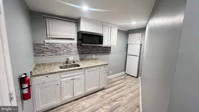 a kitchen with stainless steel appliances granite countertop a sink and cabinets