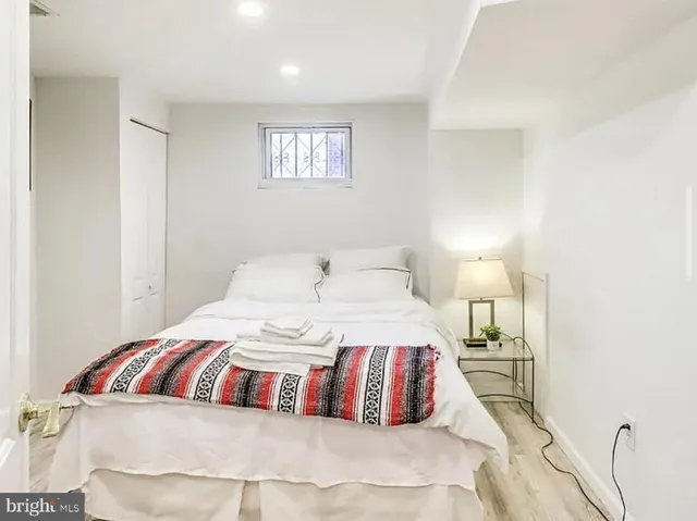 a bedroom with a bed and a night stand