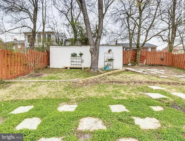 a view of a white house with a yard and garage