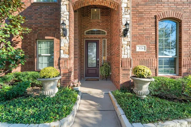 a front view of a house with potted plants
