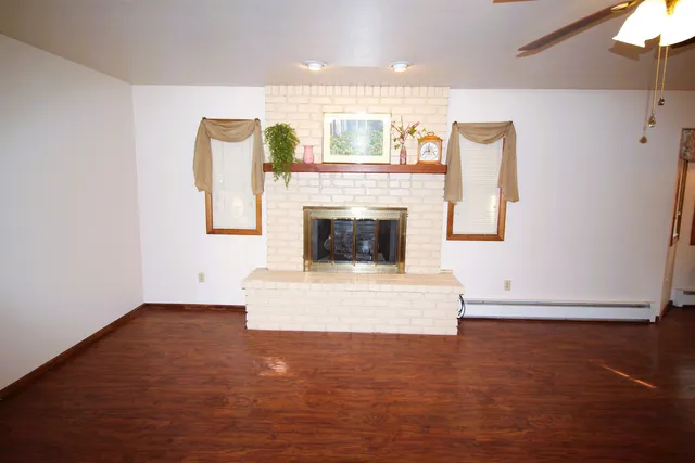 a view of living room with furniture and a kitchen