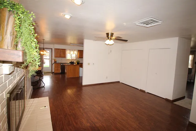 a kitchen with stainless steel appliances granite countertop wooden floors sink and cabinets