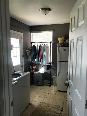 a kitchen with refrigerator and window